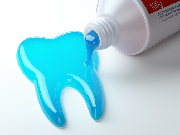 Toothpaste in the shape of tooth coming out from toothpaste tube. Brushing teeth dental concept.